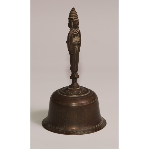 34 - A 19th century cast iron and brass desk or table bell, the base in relief with palmettes and lotus, ... 