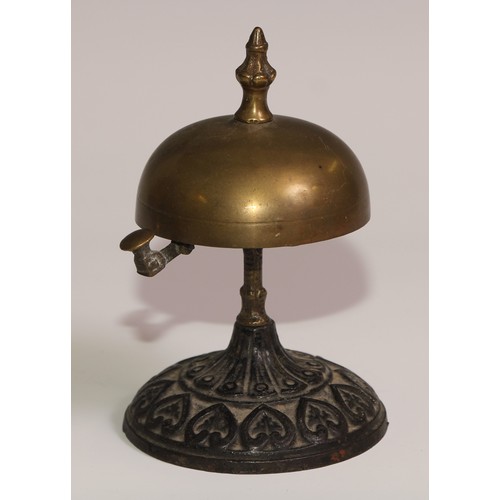 34 - A 19th century cast iron and brass desk or table bell, the base in relief with palmettes and lotus, ... 