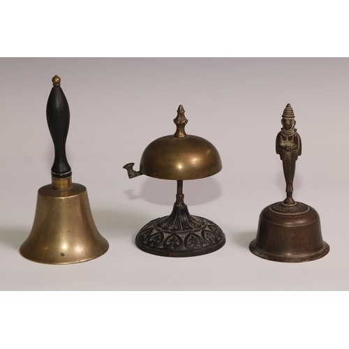 34 - A 19th century cast iron and brass desk or table bell, the base in relief with palmettes and lotus, ... 