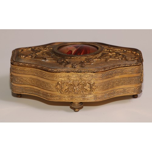 313 - A Continental gilt metal quatrefoil casket, the hinged cover centred by a porcelain plaque, decorate... 