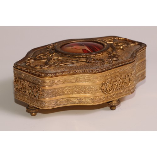 313 - A Continental gilt metal quatrefoil casket, the hinged cover centred by a porcelain plaque, decorate... 