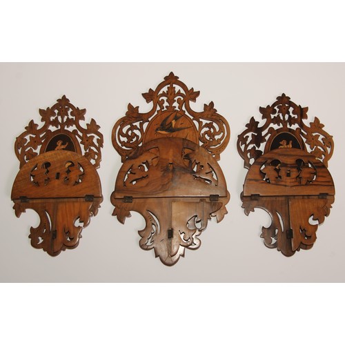 327 - A garniture of three Italian olivewood and marquetry folding wall brackets, each pierced and inlaid ... 