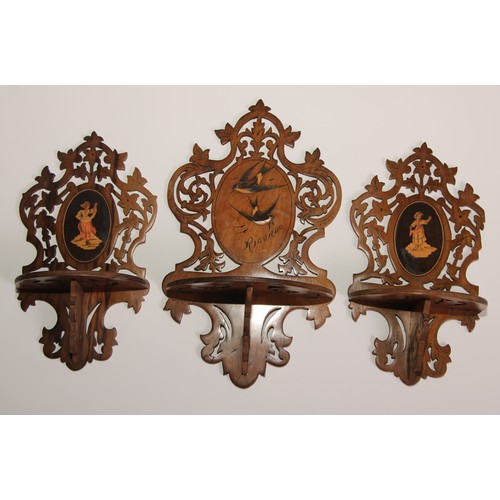 327 - A garniture of three Italian olivewood and marquetry folding wall brackets, each pierced and inlaid ... 