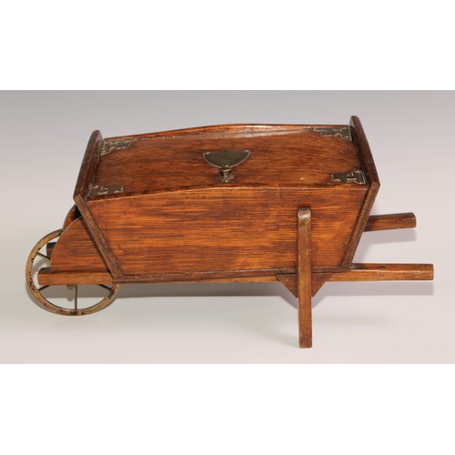 197 - A Victorian oak novelty cigar box, as a wheel barrow, hinged cover enclosing an interior fitted as a... 