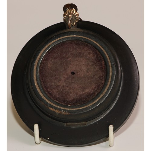 45 - A 19th century French ebonised pocket watch stand, hinged upon a dished base, 10cm diam, c.1870