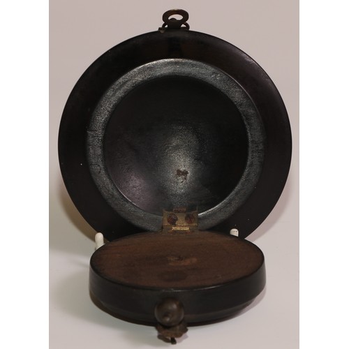 45 - A 19th century French ebonised pocket watch stand, hinged upon a dished base, 10cm diam, c.1870