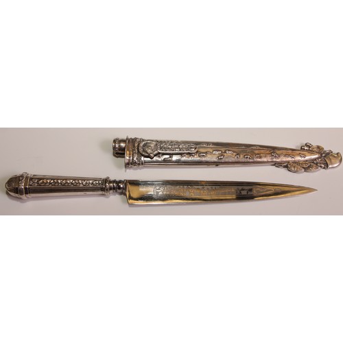 465 - A South American silvered metal gaucho knife and sheath, 18cm steel blade, decorated overall with sc... 