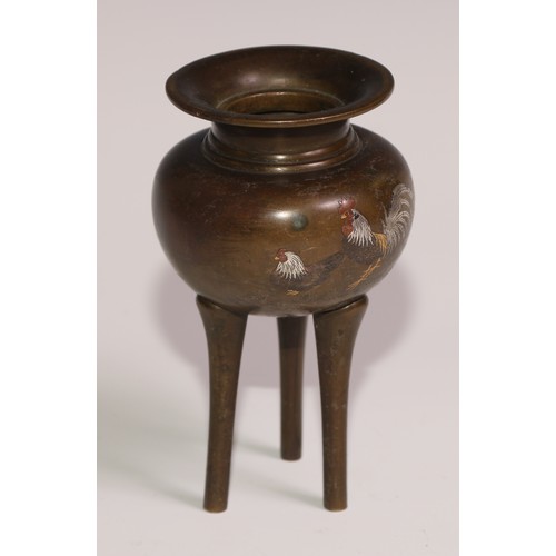 130 - A Japanese brown patinated bronze tripod koro, inlaid in silver and mixed metals with a cockerel and... 