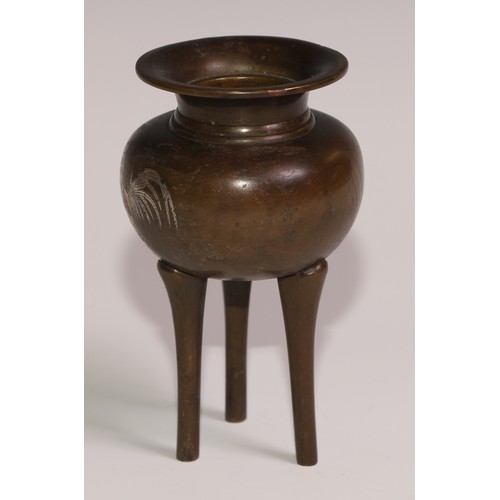 130 - A Japanese brown patinated bronze tripod koro, inlaid in silver and mixed metals with a cockerel and... 