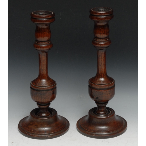 246 - Treen - a pair of 19th century turned oak table candlesticks, baluster pillars, domed bases, 33.5cm ... 