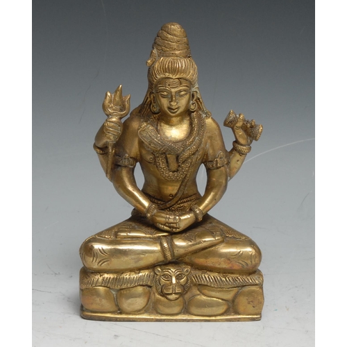 220 - Indian School (19th century), a gilt bronze, Vishnu, seated in meditation upon a lion skin, a coiled... 