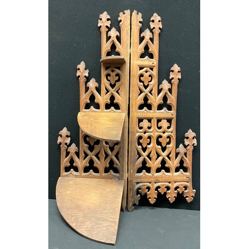 335 - A Gothic Revival oak three-tier corner waterfall wall shelf, pierced and carved with foliate tracery... 