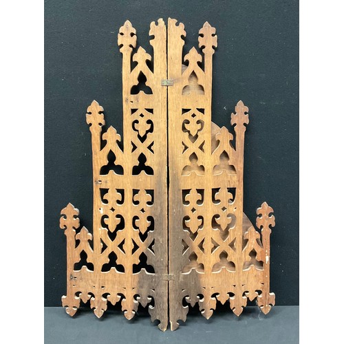 335 - A Gothic Revival oak three-tier corner waterfall wall shelf, pierced and carved with foliate tracery... 