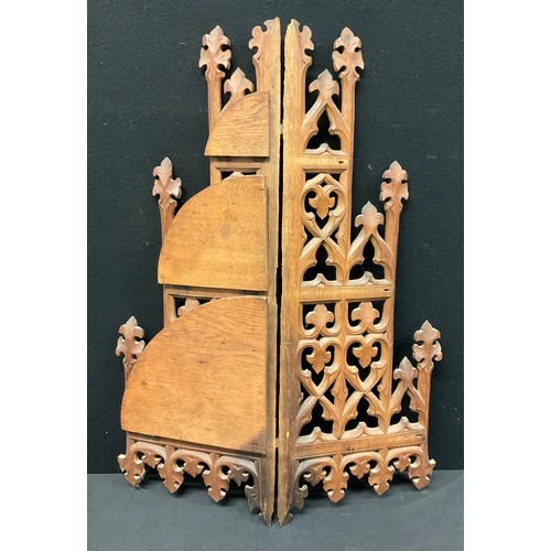 335 - A Gothic Revival oak three-tier corner waterfall wall shelf, pierced and carved with foliate tracery... 