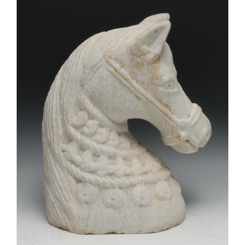 135 - A large alabaster carving, the head of a horse, wearing a bridle and elaborate tack, 40cm high