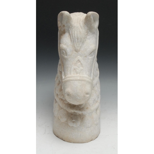 135 - A large alabaster carving, the head of a horse, wearing a bridle and elaborate tack, 40cm high