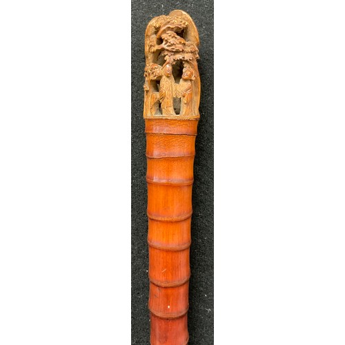 65 - A Chinese bamboo walking stick, the pommel carved in the Cantonese manner with figures amongst bloss... 