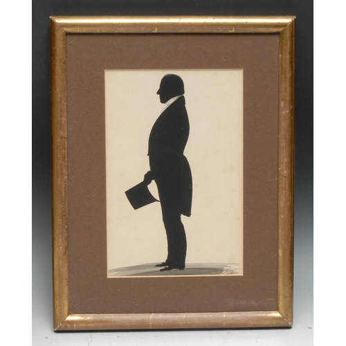 145 - English School (19th century), a large silhouette, of a gentleman, he stands, in profile, top hat in... 