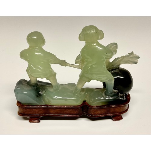 289 - A Chinese hardstone carving, of a girl and boy with a peach, hardwood stand, 18cm wide