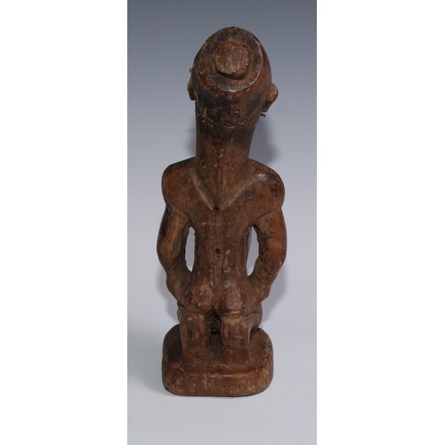 722 - Tribal Art - a Kongo power figure (nkondo nkisi), the fetish figure kneels, the chin and cheeks pier... 