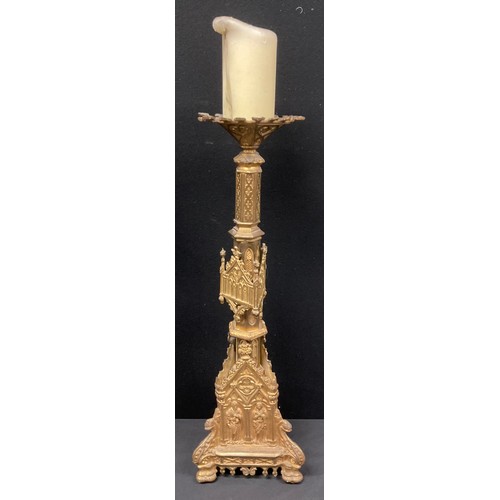 456 - A set of four Gothic Revival gilt metal altar pricket candlesticks, cast throughout with figures and... 