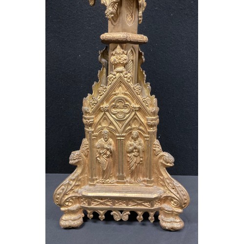 456 - A set of four Gothic Revival gilt metal altar pricket candlesticks, cast throughout with figures and... 