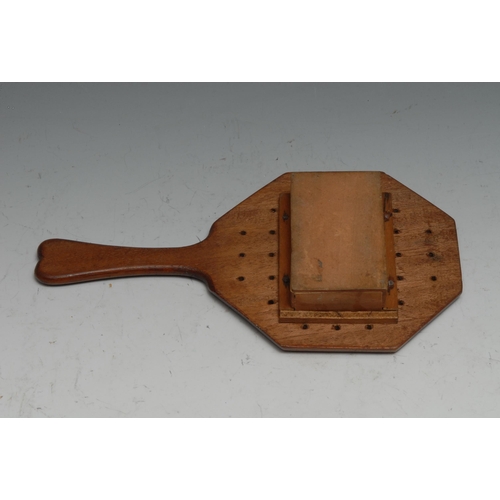 155 - Folk Art - a mahogany pan-handled solitaire board, the base with compartment enclosing bone pegs, 22... 