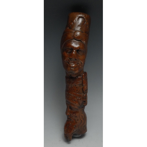 18 - A 19th century folk art walking stick handle, carved with Ottoman heads, 20cm long