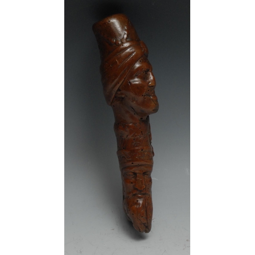 18 - A 19th century folk art walking stick handle, carved with Ottoman heads, 20cm long