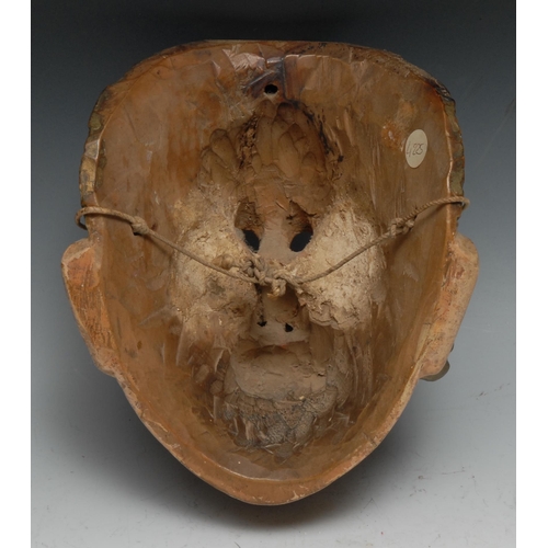 61 - A Central American folk art mask, carved as a moustached man, possibly Tecun Uman, painted in flesh ... 