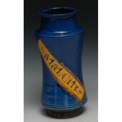 310 - A Continental albarello drug jar, inscribed Dacty Li, within a yellow banner on a blue glazed ground... 