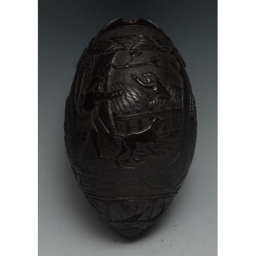 36 - A 19th century coconut bugbear, well and profusely carved with gentlemen and dogs out hunting, 15cm ... 