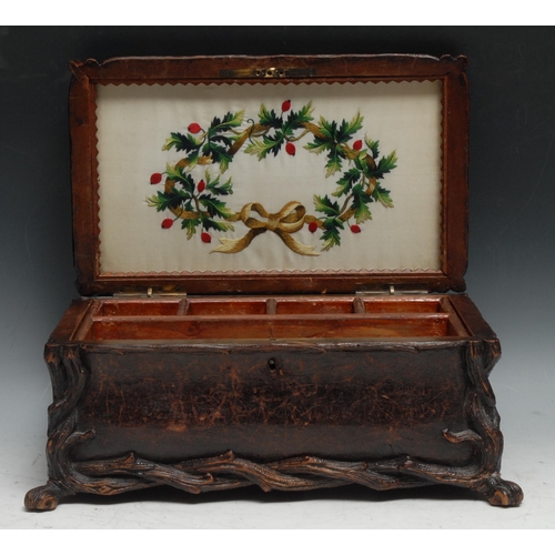 137 - A large Black Forest rectangular bombe shaped table casket, leather clad and carved with rustic bran... 