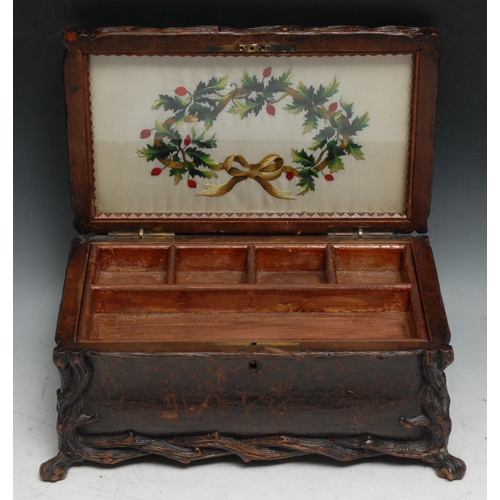 137 - A large Black Forest rectangular bombe shaped table casket, leather clad and carved with rustic bran... 