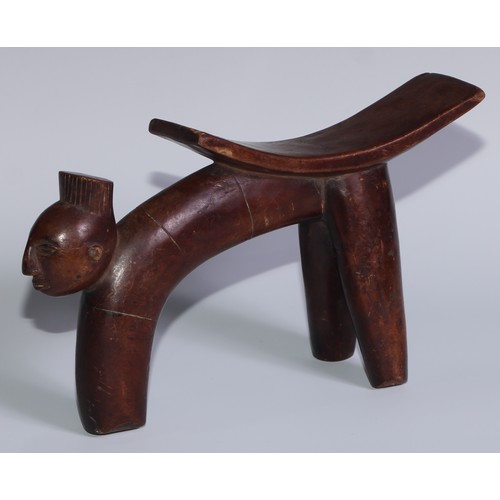 728 - Tribal Art - an African headrest, of tripod from, the projecting front support carved with a mask, 2... 