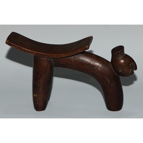 728 - Tribal Art - an African headrest, of tripod from, the projecting front support carved with a mask, 2... 