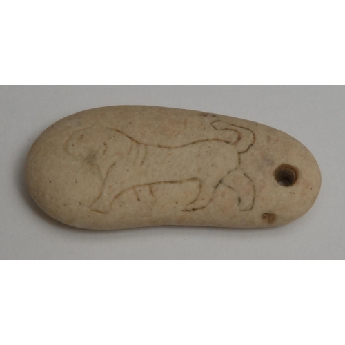 827 - Antiquities - a double-sided stone Scythian animal amulet, depicting an elk and a lion, 4.5cm wide, ... 