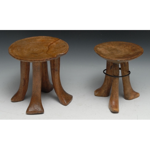 732 - Tribal Art - an Ethiopian carved tripod stool, 18.5cm high; another similar, 20cm high (2)