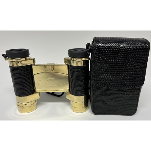 956 - A pair of Leica folding binoculars, faux black leather grips, gilt finish, 9cm long, cased