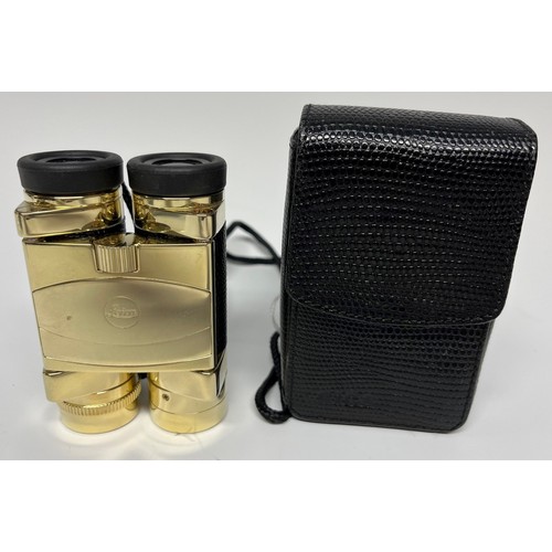 956 - A pair of Leica folding binoculars, faux black leather grips, gilt finish, 9cm long, cased