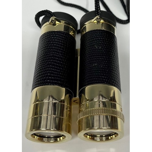 956 - A pair of Leica folding binoculars, faux black leather grips, gilt finish, 9cm long, cased