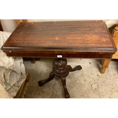 302 - A 19th century rosewood card table, rectangular top enclosing a baize-lined playing surface, egg-and... 