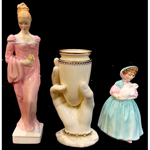 374 - A Royal Worcester posy vase, modelled as a hand holding a vessel, the sleeve with gilt and turquoise... 