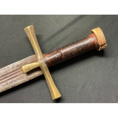 3085 - A Sudanese Kaskara sword with double edged blade 855mm in length. Brass crossguard. Leather bound gr... 