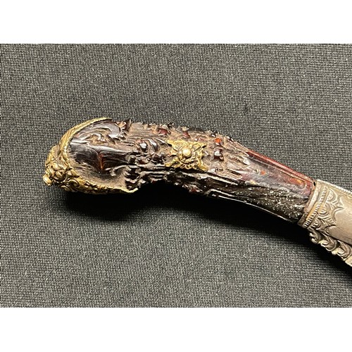 3109 - A Sinhalese Piha kaetta dagger, 15cm blade damascene in silver and koftgari, horn handle carved with... 