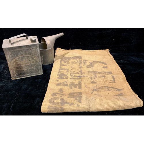 469 - An ESSO motor oil/petrol can; a galvanised watering can; a hessian sack (3)