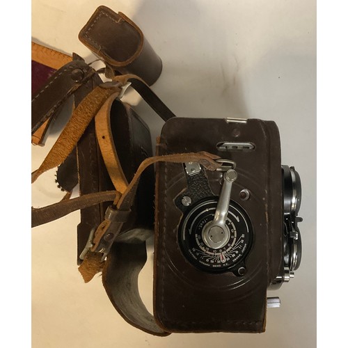 488 - A Minolta Autocord twin lens camera, Chiyoko, Rokkor lenses, number 352578, brown stretched leather ... 