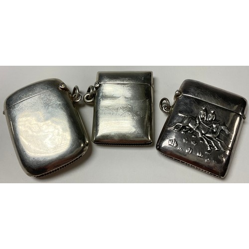 523 - A sterling silver vesta case, repousse worked with a pair of racing jockeys on horse back, suspensio... 