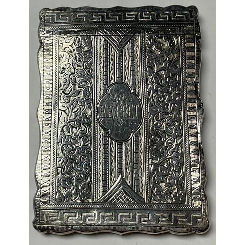 525 - A Victorian silver rounded rectangular card case, bright cut Greek key borders, engraved with traili... 