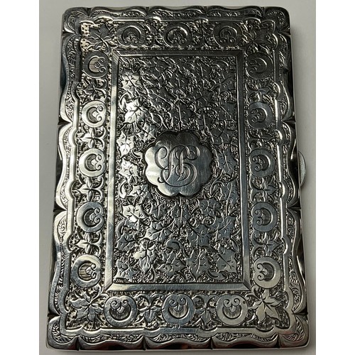 529 - A Victorian silver rounded rectangular visiting card case, engraved with trailing ivy and roundels, ... 